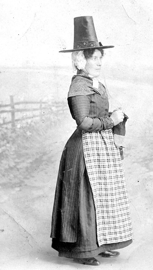 She doesn't look particularly happy, despite the hat.